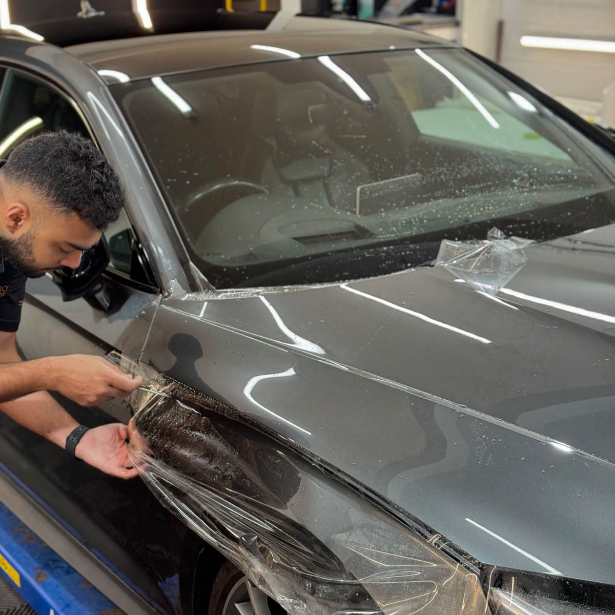 Wide PPF being fitted to a bonnet