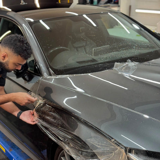 Wide PPF being fitted to a bonnet